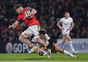 1 January 2023; Jack O'Donoghue of Munster is tackled by Billy Burns of Ulster during the United Rugby Championship between Ulster and Munster at Kingspan Stadium in Belfast. Photo by Ramsey Cardy/Sportsfile