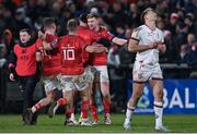 1 January 2023; Munster players celebrate with Ben Healy of Munster after he kicked the match winning conversion in the United Rugby Championship between Ulster and Munster at Kingspan Stadium in Belfast. Photo by Ramsey Cardy/Sportsfile