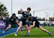 4 January 2023; Ryan Curley of Metro is tackled by Sam Manuel, right, and Jack Julian of North Midlands during the Shane Horgan Cup round three match between Metro and North Midlands at Clontarf RFC in Dublin. Photo by Harry Murphy/Sportsfile