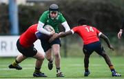 4 January 2023; Luke Hearne of South East is tackled by Oisín Carroll and Sam Manuel of North East during the Shane Horgan Cup Round Three match between South East and North East at Clontarf RFC in Dublin. Photo by Harry Murphy/Sportsfile