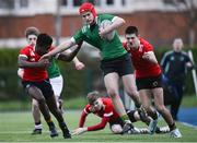 4 January 2023; Finn Soraine of South East is tackled by Hayden Casey Gray, left, and Iaasc Soden of North East during the Shane Horgan Cup Round Three match between South East and North East at Clontarf RFC in Dublin. Photo by Harry Murphy/Sportsfile