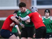 4 January 2023; Joshua Burke of South East is tackled by Cian Butler and Ruairi O'Neill of North East during the Shane Horgan Cup Round Three match between South East and North East at Clontarf RFC in Dublin. Photo by Harry Murphy/Sportsfile