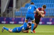 6 January 2023; John Devine of Ireland is tackled by Charlie Tector, left, and Ben Brownlee of Leinster during a friendly match between Ireland U20 and Leinster Development at Energia Park in Dublin. Photo by Seb Daly/Sportsfile