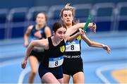 8 January 2023; Lucy Jacob, right, and Holly Eadon of Naas AC, Kildare, exchange the baton in the Senior Women's 4x400m Relay during the Athletics Ireland National League Round 1 at Sport Ireland National Indoor Arena in Dublin. Photo by Ben McShane/Sportsfile