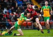 8 January 2023; Patrick Branagan of Down is tackled by Donal Mac Giolla Bhride of Donegal during the Bank of Ireland Dr McKenna Cup Round 2 match between Down and Donegal at Pairc Esler in Newry, Down. Photo by Harry Murphy/Sportsfile