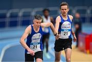 8 January 2023; Max Lara, right, and Paddy Downey of Lusk AC, Dublin, exchange the baton in the Senior Men's 4x400m Relay during the Athletics Ireland National League Round 1 at Sport Ireland National Indoor Arena in Dublin. Photo by Ben McShane/Sportsfile