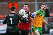 8 January 2023; Conor Francis of Down scores a point under pressure from Caolan Ward, right, and goalkeeper Michael Lynch of Donegal during the Bank of Ireland Dr McKenna Cup Round 2 match between Down and Donegal at Pairc Esler in Newry, Down. Photo by Harry Murphy/Sportsfile