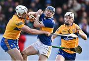 8 January 2023; Alan Tynan of Tipperary in action against Conor Cleary, left, and Brandon O'Connell of Clare during the Co-Op Superstores Munster Hurling League Group 1 match between Tipperary and Clare at McDonagh Park in Nenagh, Tipperary. Photo by Sam Barnes/Sportsfile