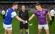 8 January 2023; The two captains, Barry John Keane of Kerins O'Rahilly's, left, and Shane Cunningham of Kilmacud Crokes, shake hands across referee Niall Cullen before the AIB GAA Football All-Ireland Senior Club Championship Semi-Final match between Kilmacud Crokes of Dublin and Kerins O'Rahilly's of Kerry at Croke Park in Dublin. Photo by Ray McManus/Sportsfile