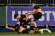 10 January 2023; Cian Béhal Valle of The King's Hospital, bottom, celebrates with teammates Luca McNally, left, and Elliot Pratt after scoring his side a try during the Bank of Ireland Vinnie Murray Cup First Round match between The King's Hospital and Newpark Comprehensive School at Energia Park in Dublin. Photo by Tyler Miller/Sportsfile
