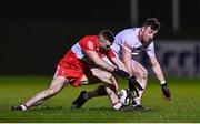 11 January 2023; Cormac Munroe of Tyrone in action against Niall Toner of Derry during the Bank of Ireland Dr McKenna Cup Round 3 match between Derry and Tyrone at Derry GAA Centre of Excellence in Owenbeg, Derry. Photo by Ben McShane/Sportsfile