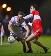 11 January 2023; Kieran McGeary of Tyrone is tackled by Padraig McGrogan of Derry during the Bank of Ireland Dr McKenna Cup Round 3 match between Derry and Tyrone at Derry GAA Centre of Excellence in Owenbeg, Derry. Photo by Ben McShane/Sportsfile