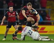 14 January 2023; Mike Haley of Munster steps over the tackle of Fraser Dingwall of Northampton Saints during the Heineken Champions Cup Pool B Round 3 match between Munster and Northampton Saints at Thomond Park in Limerick. Photo by Brendan Moran/Sportsfile