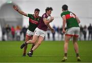 14 January 2023; Matthew Barrett of Galway in action against Jordan Flynn of Mayo during the Connacht FBD League Semi-Final match between Mayo and Galway at NUI Galway Connacht GAA Air Dome in Bekan, Mayo. Photo by Ray Ryan/Sportsfile