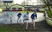 15 January 2023; Offaly players David King, left, and Jack Clancy makes their way across the St Brendan's Primary School playground to warm-up before the Walsh Cup Group 2 Round 2 match between Offaly and Wexford at St Brendan's Park in Birr, Offaly. Photo by Seb Daly/Sportsfile