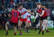 15 January 2023; Odhran Murdock of Down passes to teammate Donagh McAleenan, left, despite the attention of Shan McGuigan of Derry during the Bank of Ireland Dr McKenna Cup Semi-Final match between Down and Derry at Pairc Esler in Newry, Down. Photo by Ben McShane/Sportsfile