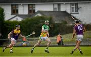 15 January 2023; Ben Conneely of Offaly in action against Conor McDonald, left, and Jack O’Connor of Wexford during the Walsh Cup Group 2 Round 2 match between Offaly and Wexford at St Brendan's Park in Birr, Offaly. Photo by Seb Daly/Sportsfile