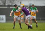 15 January 2023; David Nally of Offaly in action against Ian Carty of Wexford during the Walsh Cup Group 2 Round 2 match between Offaly and Wexford at St Brendan's Park in Birr, Offaly. Photo by Seb Daly/Sportsfile