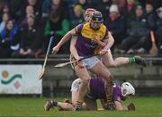 15 January 2023; Eoin Murphy of Wexford is tackled by Charlie Mitchell of Offaly during the Walsh Cup Group 2 Round 2 match between Offaly and Wexford at St Brendan's Park in Birr, Offaly. Photo by Seb Daly/Sportsfile