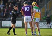 15 January 2023; Referee Caymon Flynn speak with Jack O’Connor of Wexford and Killian Sampson of Offaly  during the Walsh Cup Group 2 Round 2 match between Offaly and Wexford at St Brendan's Park in Birr, Offaly. Photo by Seb Daly/Sportsfile