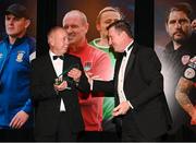14 January 2023; Mickey Harris, left, accepts the 2021 Liam Tuohy Special Merit Award, on behalf of his late brother Jerry Harris, from Liam Tuohy jnr, son of the late Liam Tuohy, during the SSE Airtricity / Soccer Writers Ireland Awards 2022 at The Clayton Hotel in Dublin. Photo by Stephen McCarthy/Sportsfile