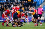 17 January 2023; Ruben Maguire of CUS is tackled by The King's Hospital players, from left, Maksym Oshodi, Cian Béhal Valle, below, and Euan Batt during the Bank of Ireland Vinnie Murray Cup Second Round match between CUS and The King’s Hospital at Energia Park in Dublin. Photo by Ben McShane/Sportsfile