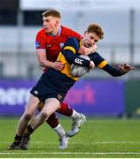 17 January 2023; Edward Nuzum of The King's Hospital is tackled by Sean Byrne of CUS during the Bank of Ireland Vinnie Murray Cup Second Round match between CUS and The King’s Hospital at Energia Park in Dublin. Photo by Ben McShane/Sportsfile