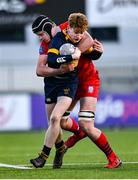 17 January 2023; Edward Nuzum of The King's Hospital is tackled by Dylan McNeice of CUS during the Bank of Ireland Vinnie Murray Cup Second Round match between CUS and The King’s Hospital at Energia Park in Dublin. Photo by Ben McShane/Sportsfile