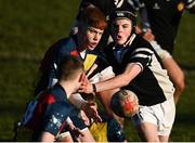 19 January 2023; Samuel O'Leary of St Fintan's High School is tackled by Ben Talt of Ardscoil na Tríonóide as he offloads during the Bank of Ireland Fr Godfrey Cup Second Round match between St Fintan's High School and Ardscoil na Tríonóide at Old Belvedere RFC in Dublin. Photo by Harry Murphy/Sportsfile