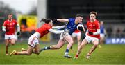 21 January 2023; Peter Lynn of Longford in action against Oisín McGuinness, left, Shane Matthews of Louth during the O'Byrne Cup Final match between Longford and Louth at Glennon Brothers Pearse Park in Longford. Photo by Ray McManus/Sportsfile