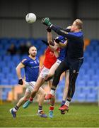 21 January 2023; Longford goalkeeper Paddy Collum punches the ball clear under pressure from his team mate Barry O'Farrell and Tom Gray of Louth during the O'Byrne Cup Final match between Longford and Louth at Glennon Brothers Pearse Park in Longford. Photo by Ray McManus/Sportsfile