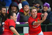 21 January 2023; Clodagh O’Halloran and Chloe Pearse of Munster celebrate with supporters after the match in the Vodafone Women’s Interprovincial Championship Round Three match between Connacht and Munster at The Sportsground in Galway. Photo by Ray Ryan/Sportsfile