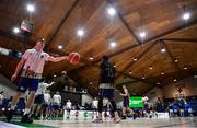 21 January 2023; University of Galway Maree players, incuding John Burke, left, warm-up before the Basketball Ireland Pat Duffy National Cup Final match between DBS Éanna and University of Galway Maree at National Basketball Arena in Tallaght, Dublin. Photo by Ben McShane/Sportsfile