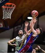 21 January 2023; John Burke of University of Galway Maree attempts a lay-up despite the attention of Kristijan Andabaka, hidden, and Nathan Comerford of DBS Éanna during the Basketball Ireland Pat Duffy National Cup Final match between DBS Éanna and University of Galway Maree at National Basketball Arena in Tallaght, Dublin. Photo by Ben McShane/Sportsfile