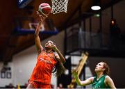 22 January 2023; Chyna Latimer of Killester scores a lay-up despite the attention of Claire Melia of Trinity Meteors during the Basketball Ireland Paudie O'Connor National Cup Final match between Trinity Meteors and Killester at National Basketball Arena in Tallaght, Dublin. Photo by Ben McShane/Sportsfile