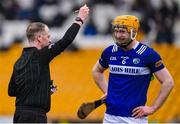22 January 2023; Referee Chris Mooney shows a yellow card to Padraig Delaney of Laois during the Walsh Cup Group 2 Round 3 match between Offaly and Laois at Glenisk O'Connor Park in Tullamore, Offaly. Photo by Tyler Miller/Sportsfile