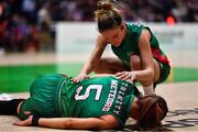22 January 2023; Dayna Finn of Trinity Meteors, 5, is assisted by teammate Mireia Riera after picking up an injury during the Basketball Ireland Paudie O'Connor National Cup Final match between Trinity Meteors and Killester at National Basketball Arena in Tallaght, Dublin. Photo by Ben McShane/Sportsfile