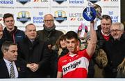 21 January 2023; Shane McGuigan of Derry holds aloft the Dr McKenna cup with Chris Heaton-Harris,centre, MP and Secretary of state for Northern Ireland watching on after the Bank of Ireland Dr McKenna Cup Final match between Derry and Tyrone at Athletic Grounds in Armagh. Photo by Oliver McVeigh/Sportsfile