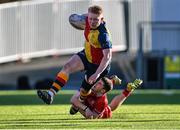 24 January 2023; Rory O'Connor O'Hehir of St Fintans High School is tackled by Sean Turner of CUS during the Bank of Ireland Vinnie Murray Cup Semi-Final match between St Fintans High School and CUS at Energia Park in Dublin. Photo by Tyler Miller/Sportsfile