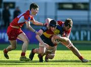 24 January 2023; Robert Harvey of St Fintans High School is tackled by Dualta Larkin, right, and Sean Turner of CUS during the Bank of Ireland Vinnie Murray Cup Semi-Final match between St Fintans High School and CUS at Energia Park in Dublin. Photo by Tyler Miller/Sportsfile