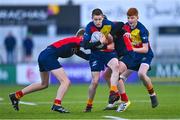 26 January 2023; Tadg Young of St Fintans High School is tackled by Fionn Moriarty, left, and Corey O'Brien of Temple Carrig during the Bank of Ireland Fr Godfrey Cup Semi-Final match between St Fintans High School and Temple Carrig at Energia Park in Dublin. Photo by Ben McShane/Sportsfile