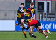 26 January 2023; Tadg Young of St Fintans High School is tackled by Corey O'Brien of Temple Carrig during the Bank of Ireland Fr Godfrey Cup Semi-Final match between St Fintans High School and Temple Carrig at Energia Park in Dublin. Photo by Ben McShane/Sportsfile