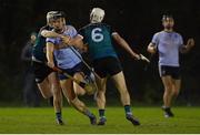 26 January 2023; Colum Prendiville of UCD is tackled by Liam Cassin, left, and Conan Boran of Maynooth University during the HE GAA Fitzgibbon Cup Round 2 match between Maynooth University and University College Dublin at the Maynooth University North Campus in Kildare. Photo by Tyler Miller/Sportsfile