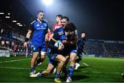 28 January 2023; Max O'Reilly of Leinster celebrates with teammates Liam Turner, right, and Scott Penny, left, after scoring their side's fifth try during the United Rugby Championship match between Leinster and Cardiff at RDS Arena in Dublin. Photo by Ben McShane/Sportsfile