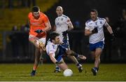 28 January 2023; Tiernan Kelly of Armagh shoots at goal despite the tackle of Killian Lavelle of Monaghan during the Allianz Football League Division 1 match between Monaghan and Armagh at St Mary's Park in Castleblayney, Monaghan. Photo by Ramsey Cardy/Sportsfile