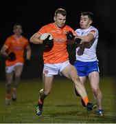 28 January 2023; Rian O'Neill of Armagh is tackled by Micheál Bannigan of Monaghan during the Allianz Football League Division 1 match between Monaghan and Armagh at St Mary's Park in Castleblayney, Monaghan. Photo by Ramsey Cardy/Sportsfile