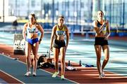 29 January 2023; Athletes, from left, Sarah Mc Carthy of Mid Sutton AC, Dublin, Lucy-May Sleeman of Leevale AC, Cork and Cliodhna Manning of Kilkenny City Harriers AC, Kilkenny, make their way to the starting blocks before competing in the Women's Senior 200m during the 123.ie AAI Indoor Games at the TUS International arena in Athlone, Westmeath. Photo by Ben McShane/Sportsfile