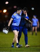 2 February 2023; David Crowe of UCD is helped from the pitch by physiotherapist Conor Duffy during the HE GAA Fitzgibbon Cup Group C match between University College Dublin and University College Cork at Billings Park in Belfield, Dublin. Photo by Seb Daly/Sportsfile