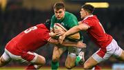 4 February 2023; Garry Ringrose of Ireland is tackled by Tomas Francis and Joe Hawkins, right, of Wales during the Guinness Six Nations Rugby Championship match between Wales and Ireland at Principality Stadium in Cardiff, Wales. Photo by Brendan Moran/Sportsfile