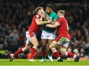 4 February 2023; Bundee Aki of Ireland is tackled by Dan Biggar, left, and Jac Morgan of Wales during the Guinness Six Nations Rugby Championship match between Wales and Ireland at Principality Stadium in Cardiff, Wales. Photo by Brendan Moran/Sportsfile